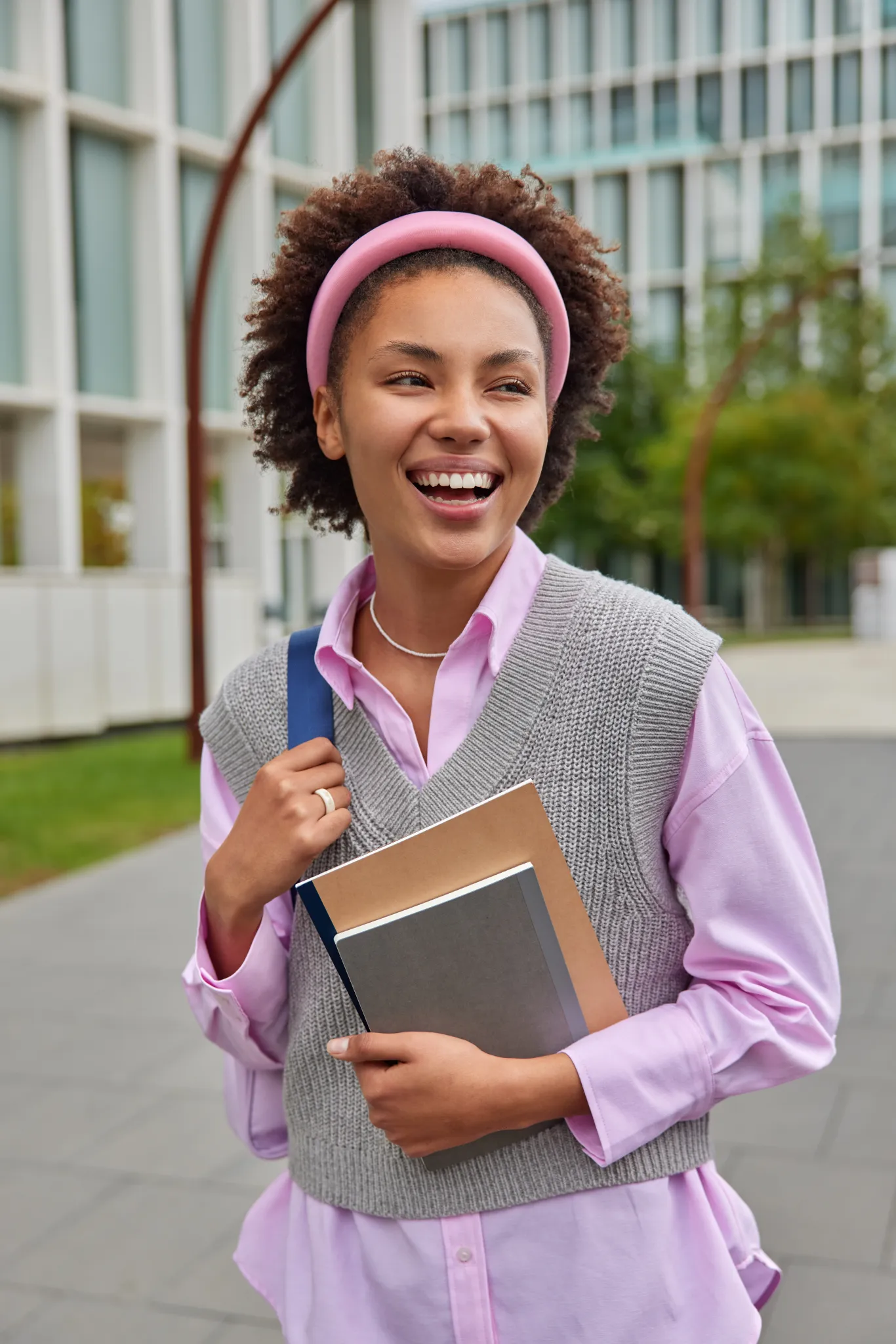 Smiling student holding notebooks