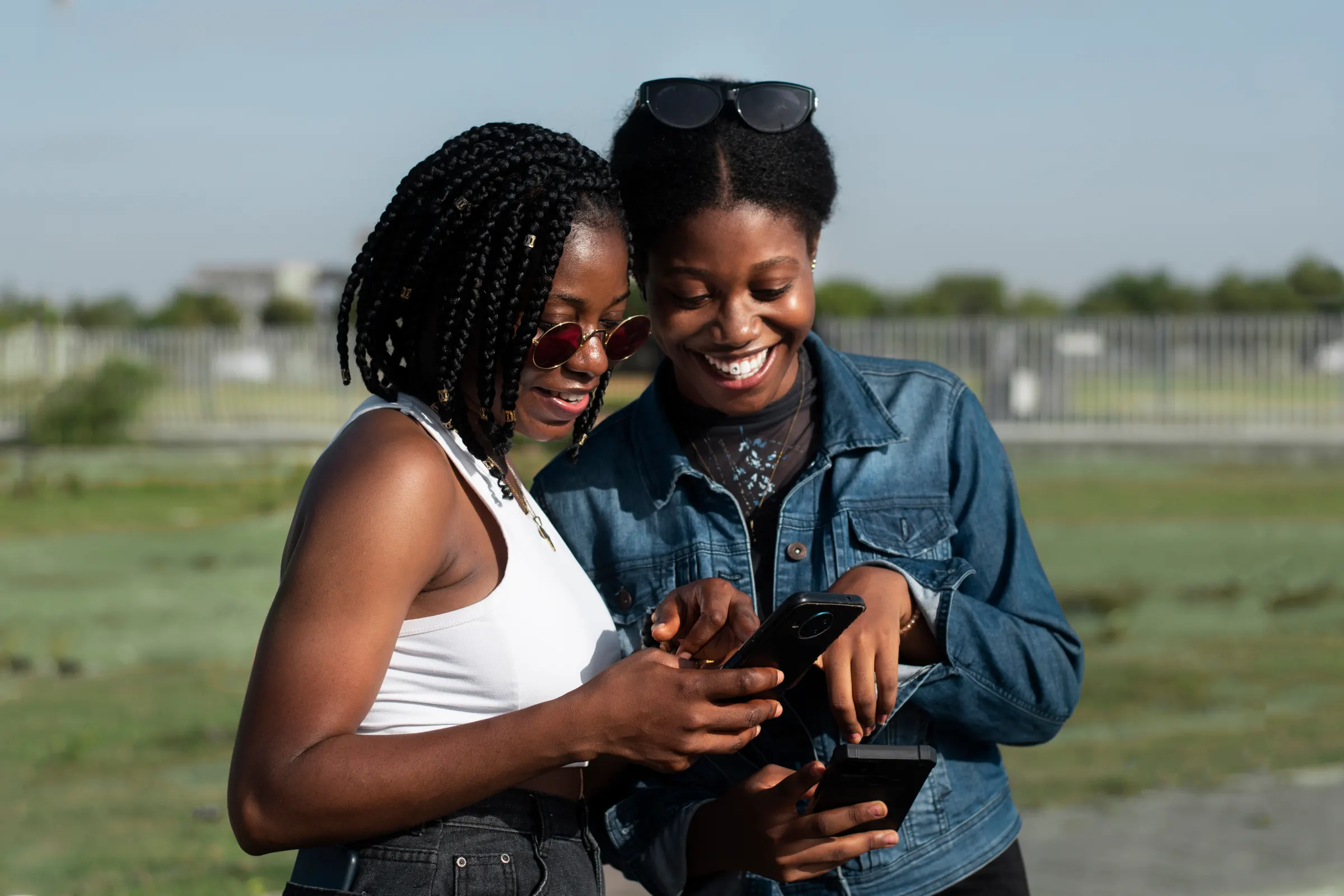 Two friends smiling at a phone