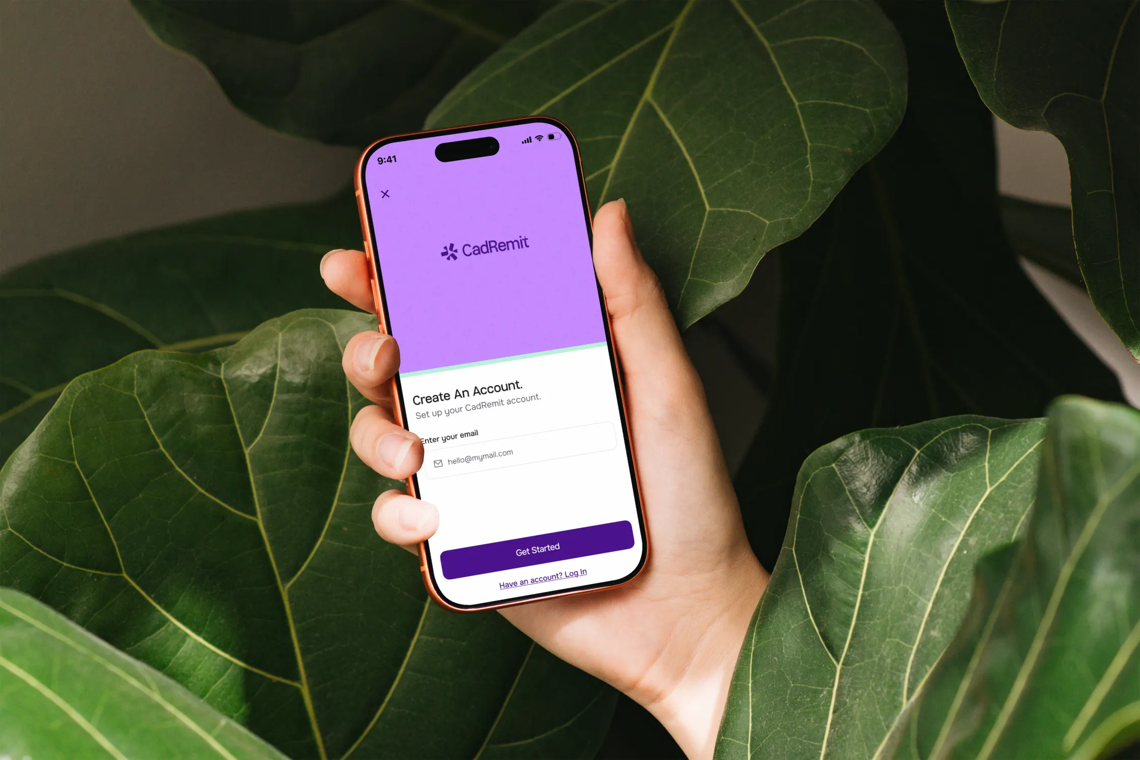 Hand holding a phone showing the CadRemit sign-up screen