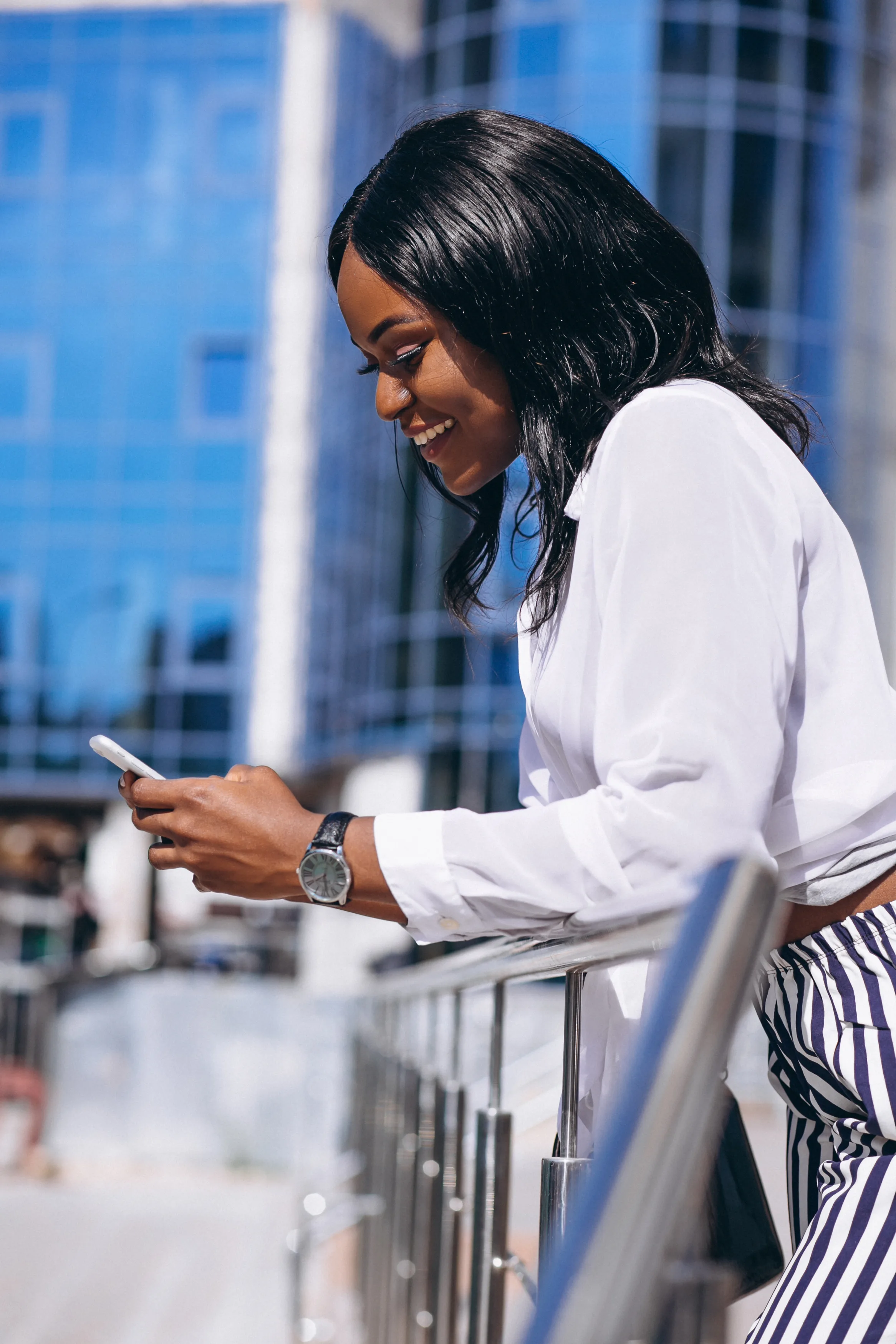 Woman smiling while using her phone